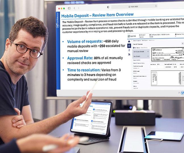 A man gesturing to a computer screen which is showing an observation summary presentation